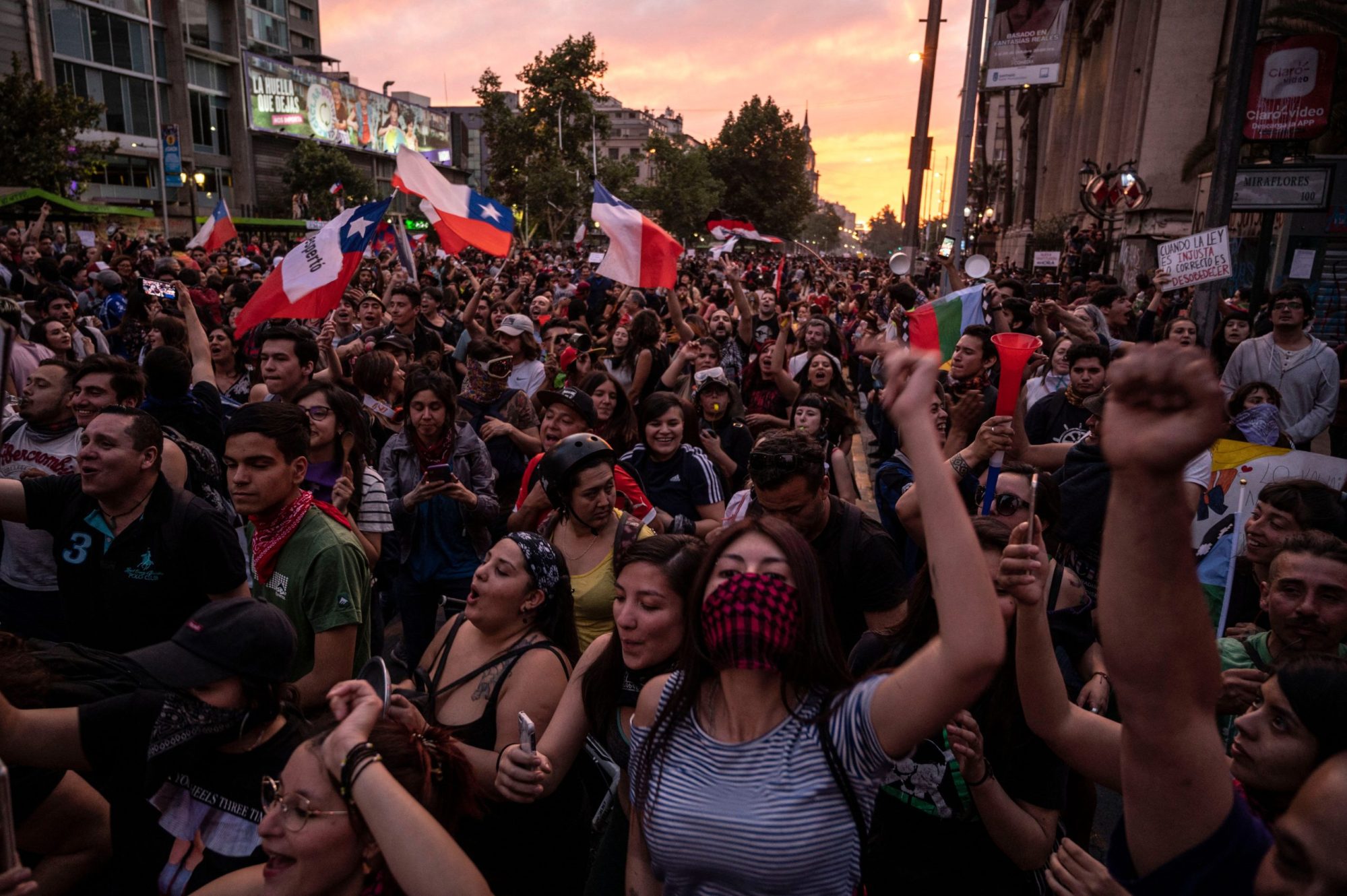 Demonstrators gather in Santiago, on October 25, 2019, a week after protests started. Demonstrations against a hike in metro ticket prices in Chile's capital exploded into violence on October 18, unleashing widening protests over living costs and social inequality. Photo by PEDRO UGARTE/AFP via Getty Images