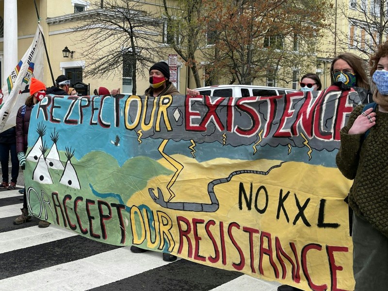 Activists display banners referring to the shutting down of existing oil pipelines in the northern United States at Black Lives Matter Plaza in Washington, DC on April 1, 2021, one block from the White House as US President Joe Biden was holding his first cabinet meeting.