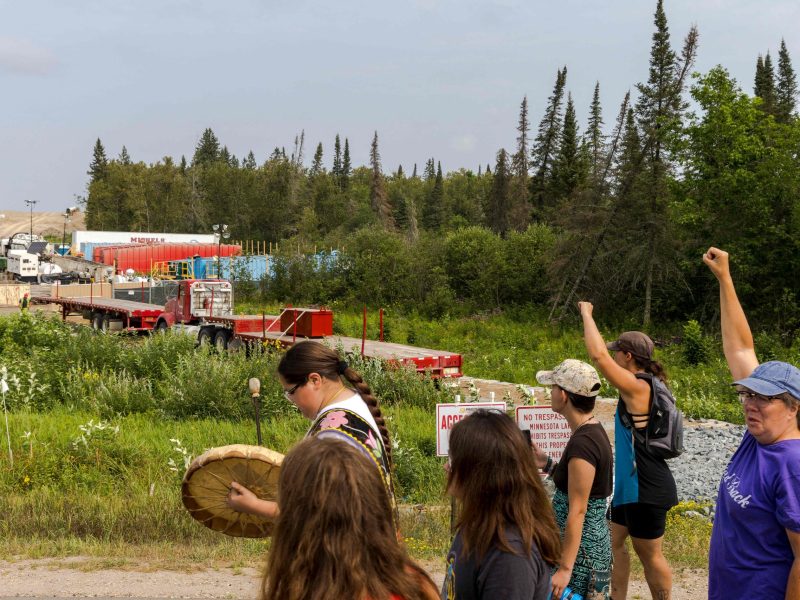 A group of indigenous people and activists raise their fists as they pass Sections of the Enbridge Line 3 pipeline construction during the 'Treaty People Walk for Water' event near the La Salle Lake State Park in Solway, Minnesota on August 7, 2021. Photo by KEREM YUCEL/AFP via Getty Images