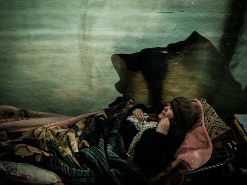 Woman lying down in blankets.