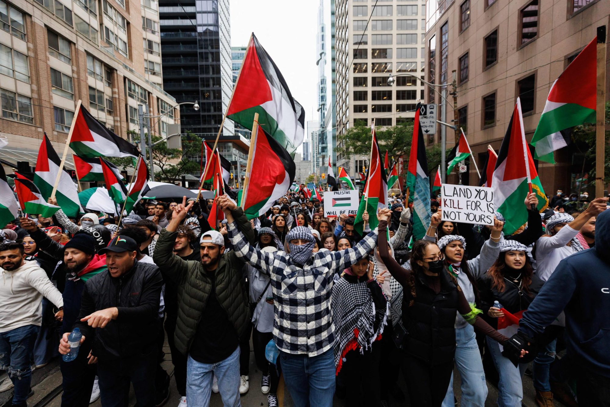 Demonstrators in support of Palestinians wave Palestinian flags during a protest in Toronto, Ontario, Canada, on October 9, 2023.