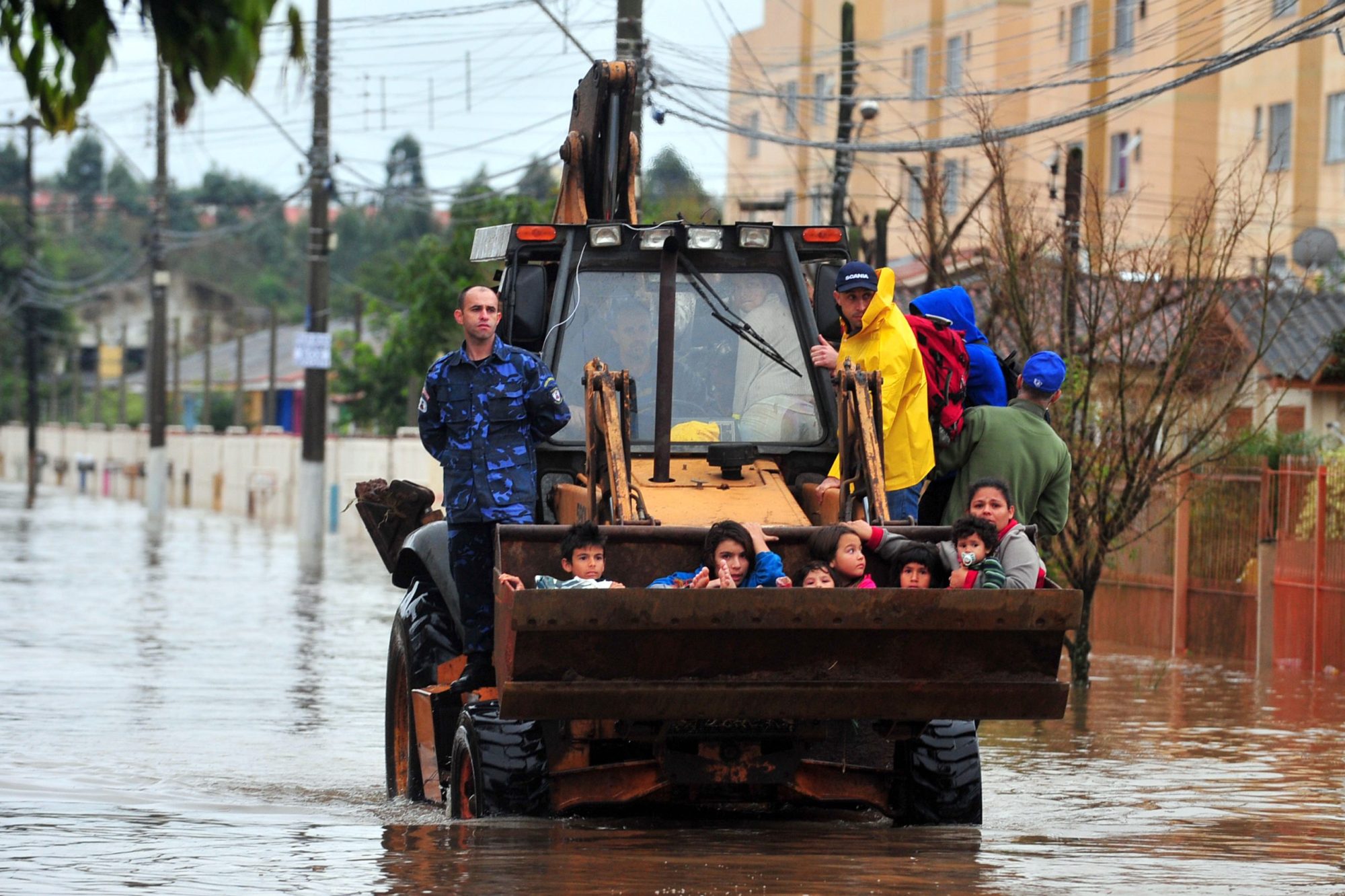 Gravatai, Rio Grande do Sul, Brazil - Jul 14th, 2015: Children are rescued from the flood in a backhoe