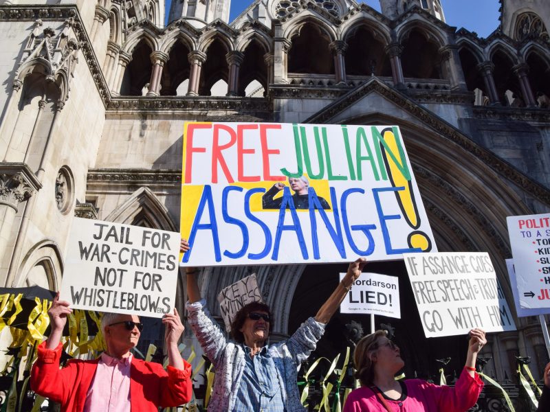 Protesters hold placards in support of Julian Assange during a demonstration outside the High Court ahead of Assange's extradition decision. Photo by Vuk Valcic/SOPA Images/LightRocket via Getty Images