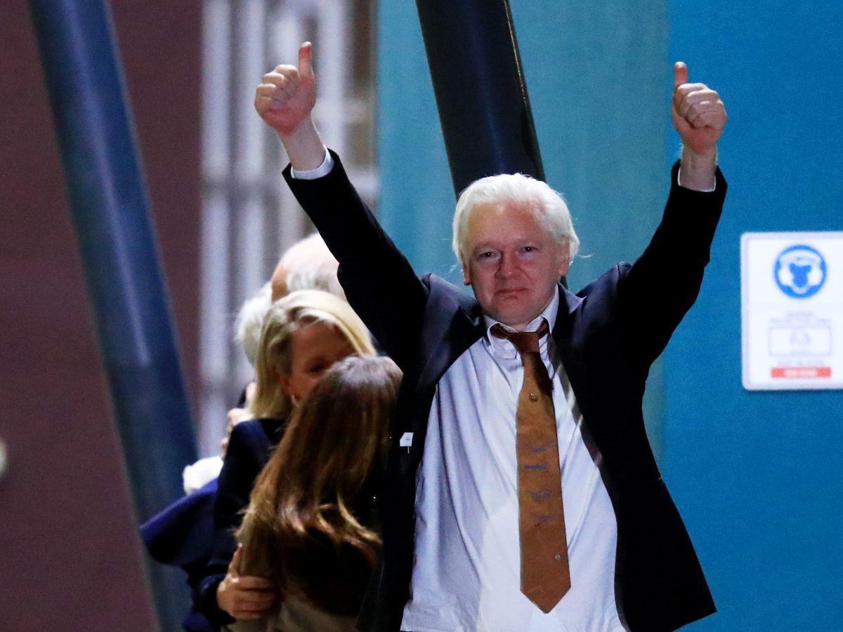 WikiLeaks founder Julian Assange gestures as he arrives at Canberra Airport on June 26, 2024 in Canberra, Australia. Photo by Roni Bintang/Getty Images