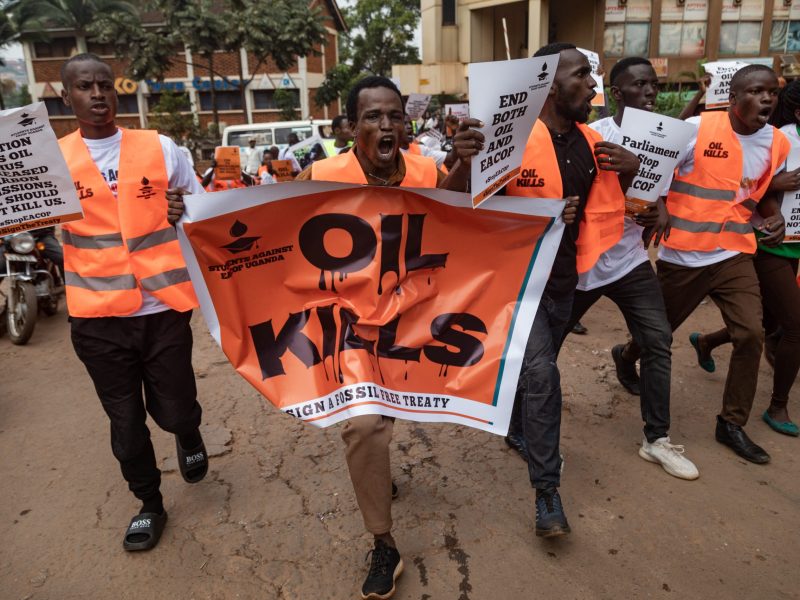 Environmental activists hold banners and chant slogans as they protest against the East African Crude Oil Pipeline Project (EACOP) in Kampala on August 26, 2024. Photo by BADRU KATUMBA/AFP via Getty Images