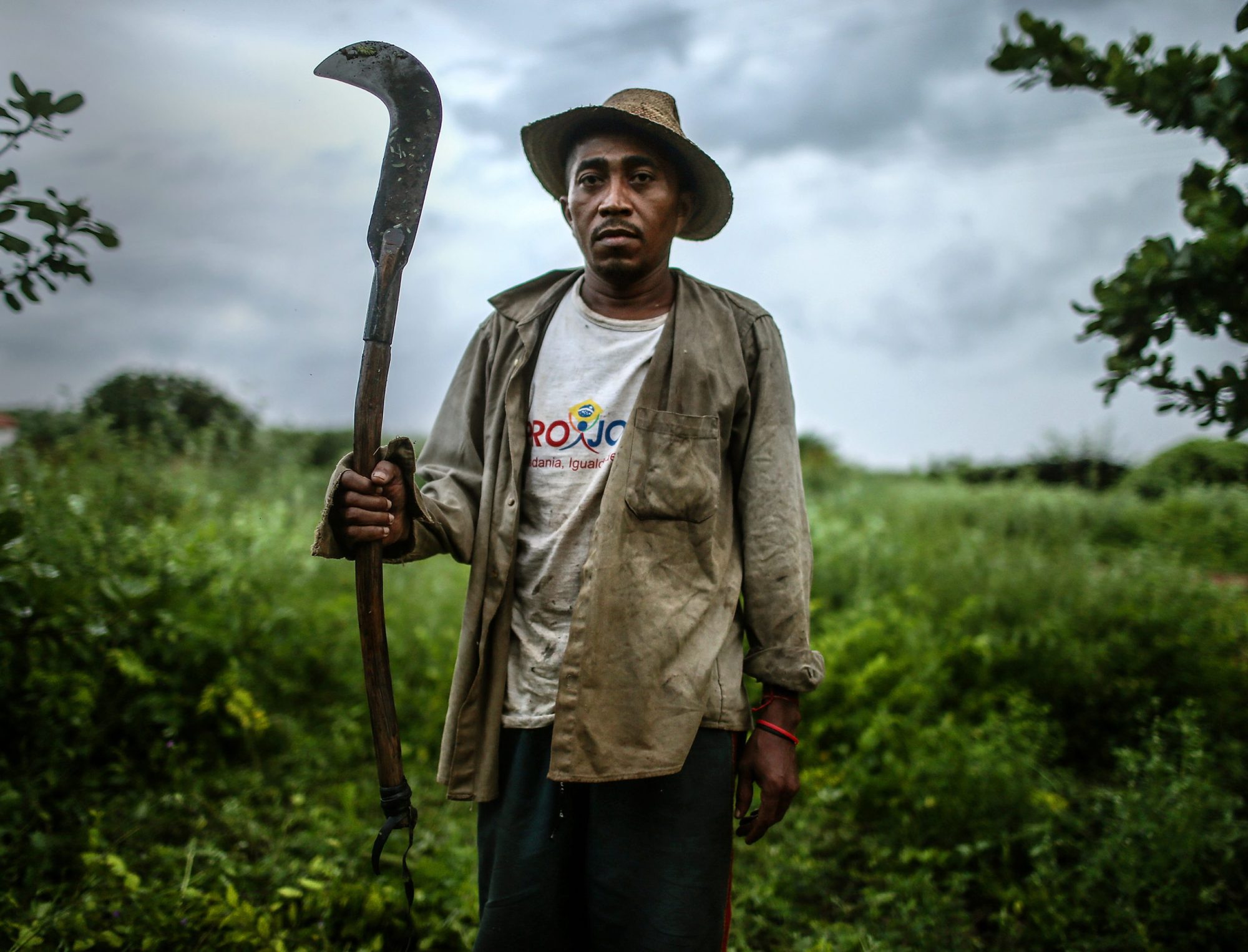 Former slave Francisco Rodrigues dos Santos poses with his sickle on the piece of land where he lives and farms at the Nova Conquista settlement on April 8, 2015 in Monsenhor Gil, Piauí state, Brazil. Photo by Mario Tama/Getty Images