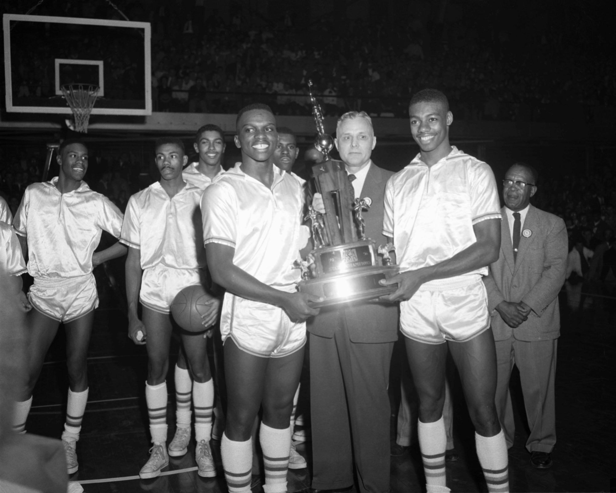 Members of the Crispus Attucks Tigers accept the 1956 Indiana State High School Boys Basketball Championship trophy after the game in March, 1956 against the Lafayette Jefferson Bronchos in March, 1956 at the Butler Fieldhouse in Indianapolis, Indiana. Photo by:Diamond Images/Getty Images